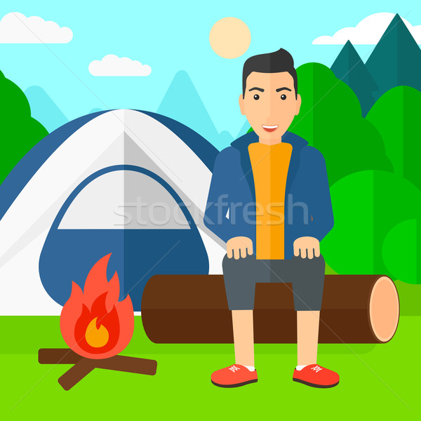 Hombre sesión campamento fuego camping Foto stock © RAStudio