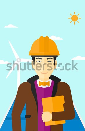 Female worker of solar power plant and wind farm. Stock photo © RAStudio