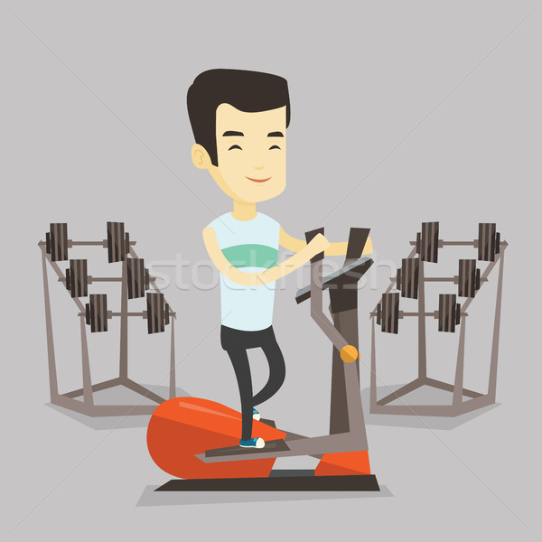 Man exercising on elliptical trainer. Stock photo © RAStudio
