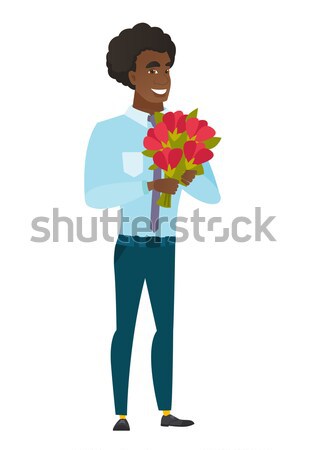 African groom holding a bouquet of flowers. Stock photo © RAStudio