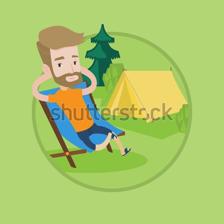 Man sitting in folding chair in the camp. Stock photo © RAStudio