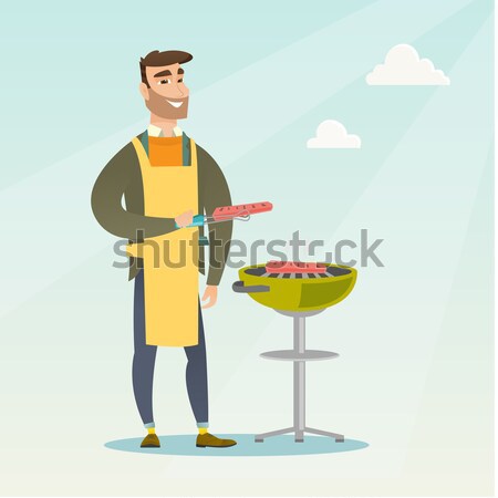 Chef cook cooking steak on barbecue grill. Stock photo © RAStudio