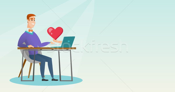 Fiatalember laptopot használ online randizás kaukázusi férfi Stock fotó © RAStudio