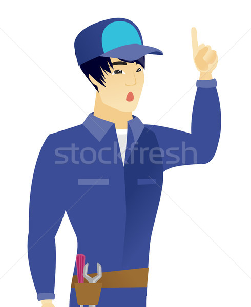 Stock photo: Asian mechanic with open mouth pointing finger up.