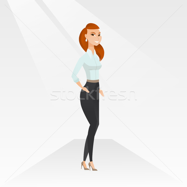 Stock photo: Woman posing on catwalk during fashion show.