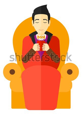 Man sitting in chair with cup of tea. Stock photo © RAStudio