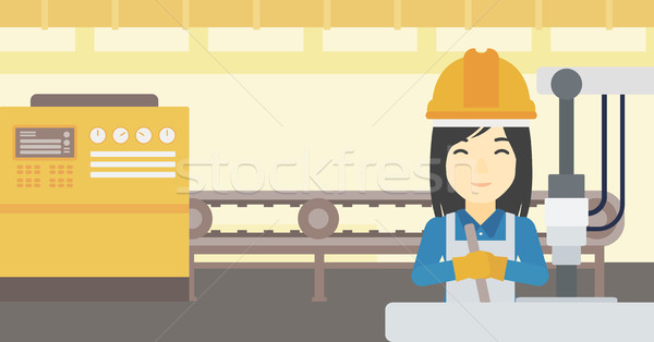 Stock photo: Woman working on industrial drilling machine.