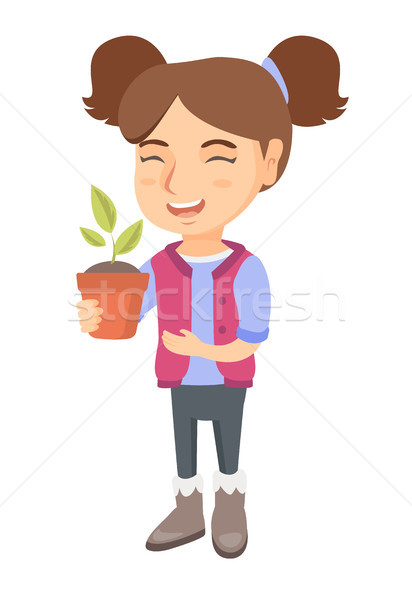 Caucasian smiling girl holding a potted plant. Stock photo © RAStudio