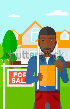 Stock photo: Real estate agent signing contract.