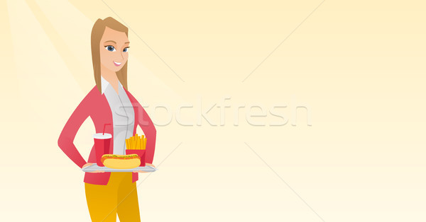 Woman holding tray full of fast food. Stock photo © RAStudio