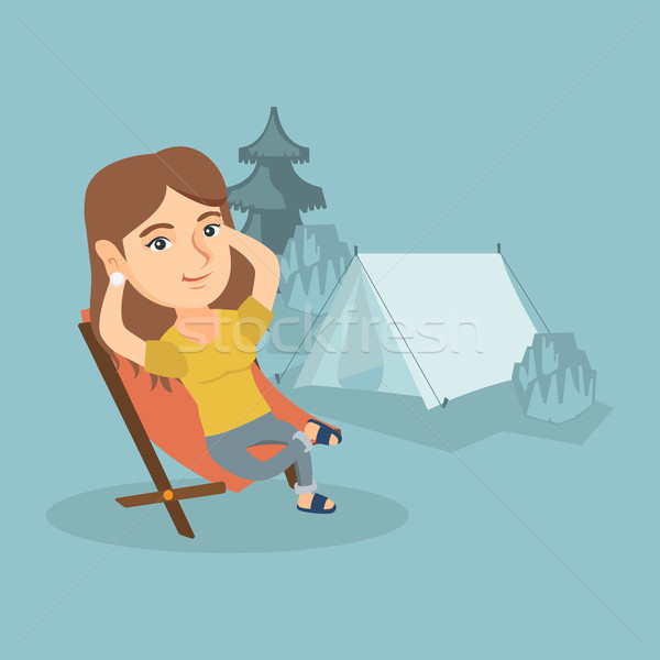 Woman sitting in a folding chair in the camping. Stock photo © RAStudio