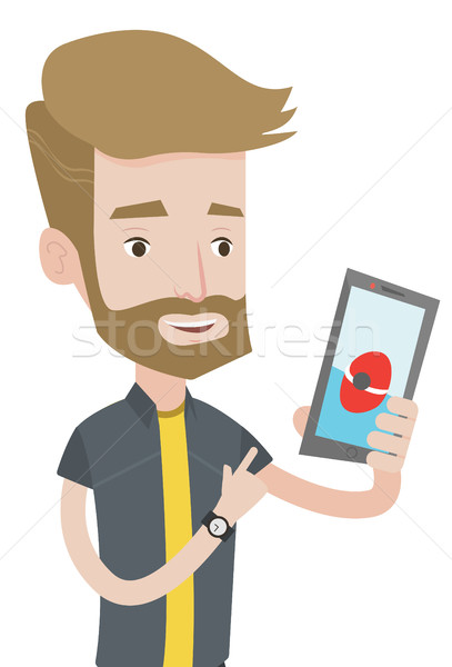 Stock photo: Man playing action game on smartphone