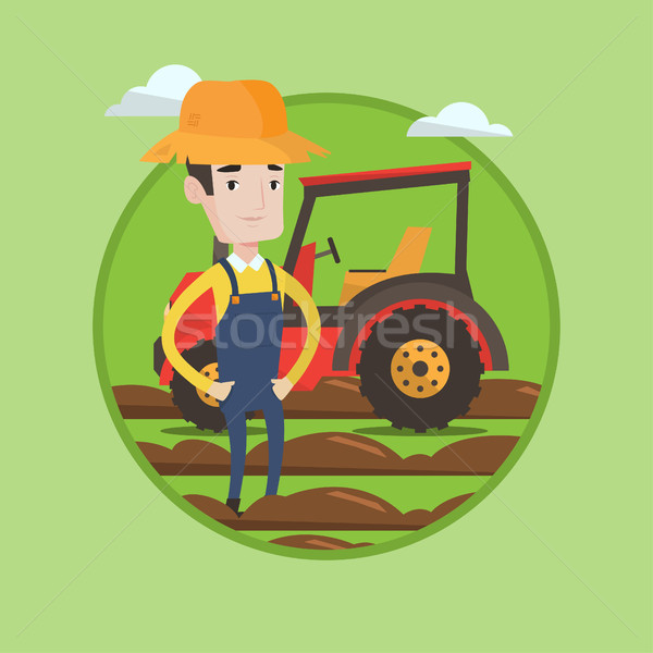 Farmer standing with tractor on background. Stock photo © RAStudio