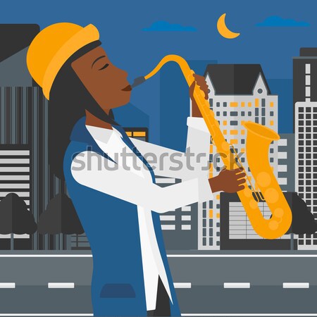 Mujer jugando saxófono músico noche ciudad Foto stock © RAStudio