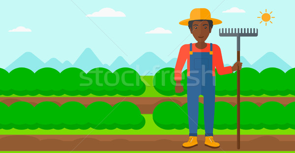 Agricultor rastrillo hombre pie campo Foto stock © RAStudio