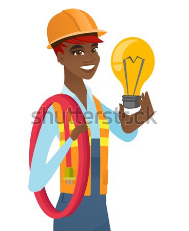 Builder holding bright idea light bulb. Stock photo © RAStudio