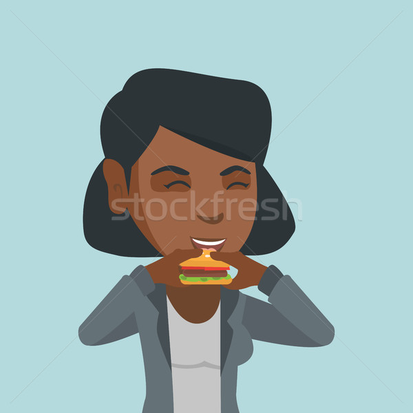 Young african joyful woman eating hamburger. Stock photo © RAStudio