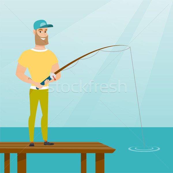 Stock photo: Young caucasian man fishing on jetty.