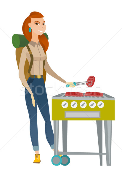 Traveler woman cooking steak on barbecue grill. Stock photo © RAStudio