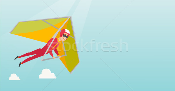 Young caucasian man flying on hang-glider. Stock photo © RAStudio