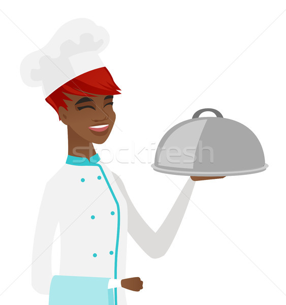 Young african chef holding towel and cloche. Stock photo © RAStudio