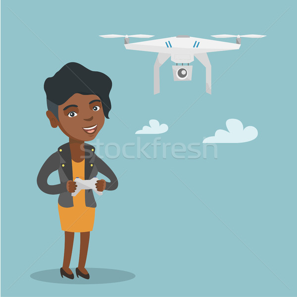 Young african-american woman flying drone. Stock photo © RAStudio