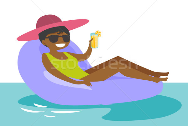 African-american woman relaxing in swimming pool. Stock photo © RAStudio