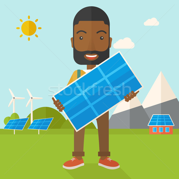 African man holding a solar panel. Stock photo © RAStudio