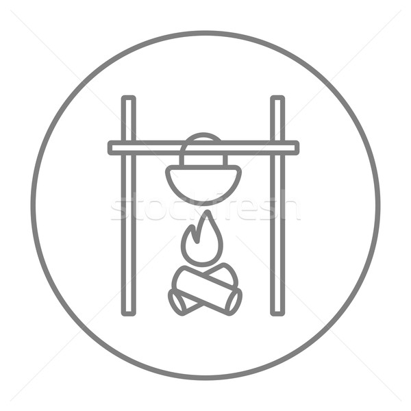 Cooking in cauldron on campfire line icon. Stock photo © RAStudio