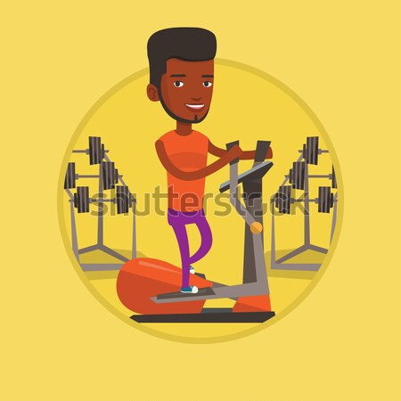 Man exercising on elliptical trainer. Stock photo © RAStudio