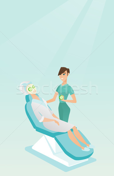 Cosmetologist making beauty treatments to a woman. Stock photo © RAStudio