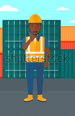 Port worker talking on wireless radio. Stock photo © RAStudio
