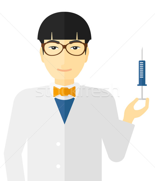 Doctor holding syringe. Stock photo © RAStudio