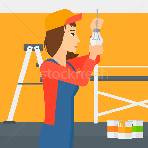 Electrician twisting light bulb. Stock photo © RAStudio