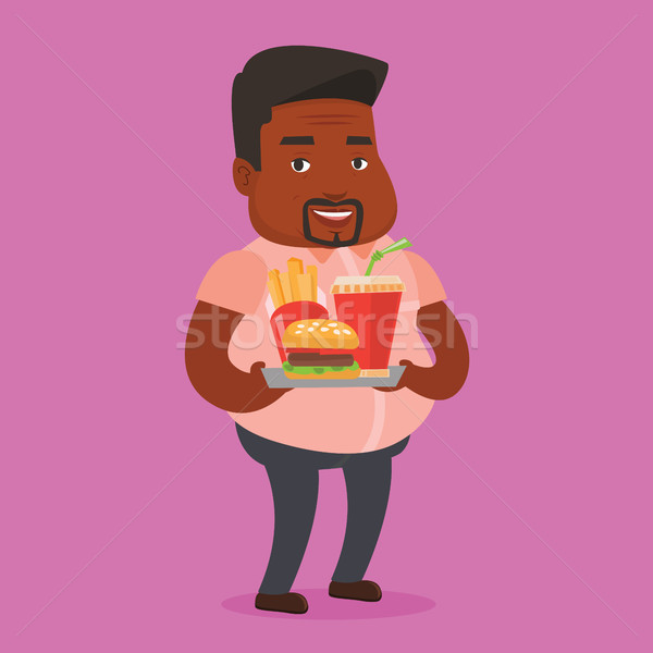 Man holding tray full of fast food. Stock photo © RAStudio