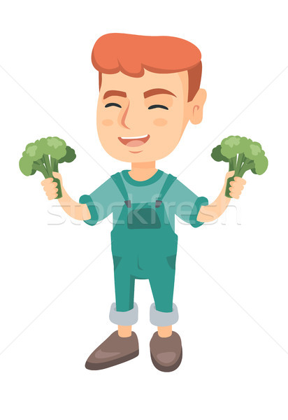 Little caucasian boy laughing and holding broccoli Stock photo © RAStudio