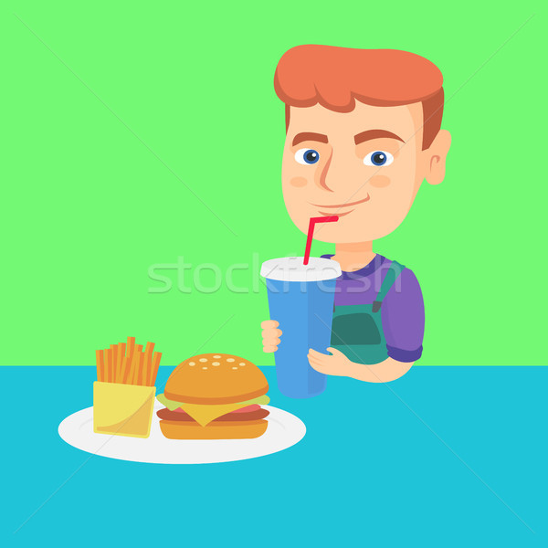 Little boy drinking soda and eating cheeseburger. Stock photo © RAStudio