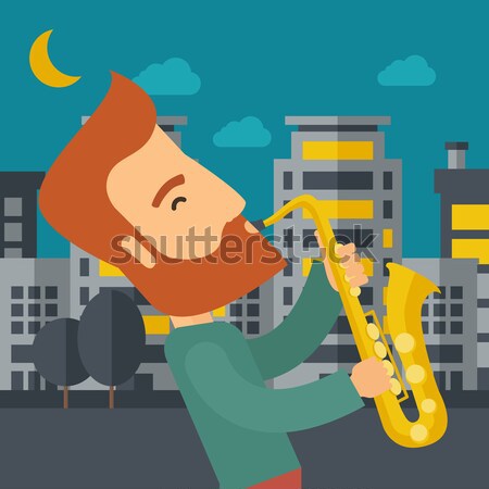 Saxophonist playing in the streets at night Stock photo © RAStudio