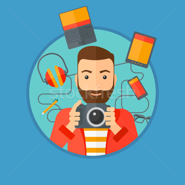 Young man surrounded with his gadgets. Stock photo © RAStudio