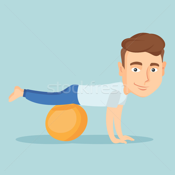 Young man exercising with fitball. Stock photo © RAStudio