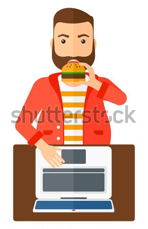 Man eten hamburger vet permanente laptop Stockfoto © RAStudio
