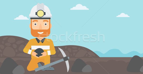 Stock photo: Miner holding coal in hands.