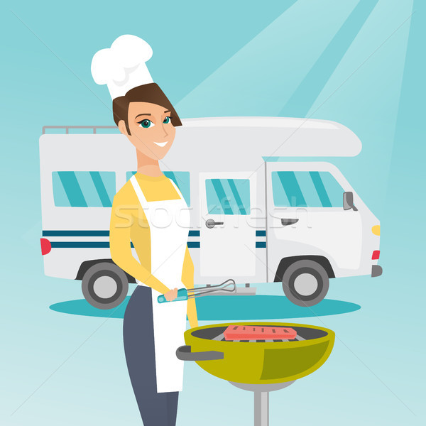 Stock photo: Woman barbecuing meat in front of camper van.