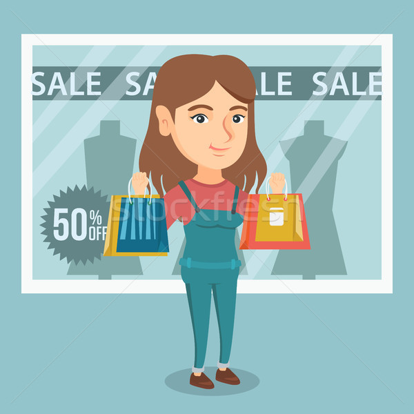 Stock photo: Young caucasian woman shopping on sale.