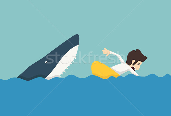 Businessman swimming to escape sharks Stock photo © ratch0013