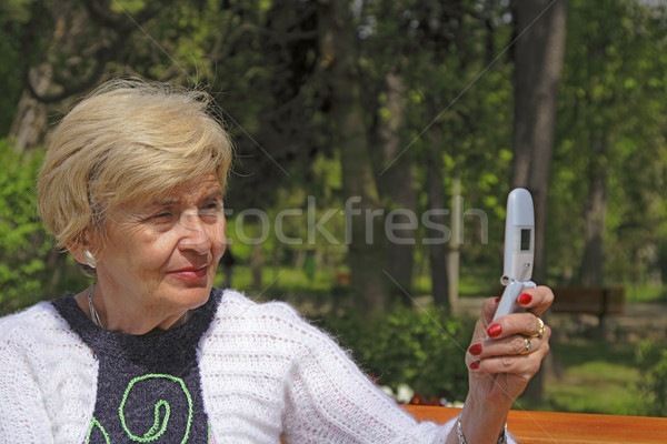 Senior woman with camera phone Stock photo © RazvanPhotography