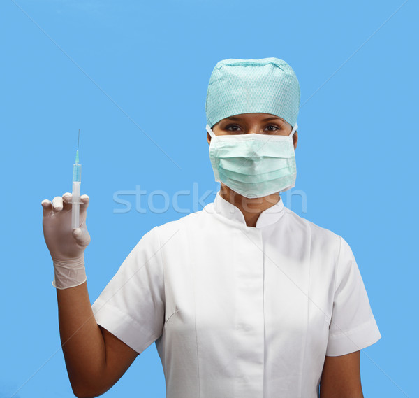 Stock photo: Female nurse holding a syringe