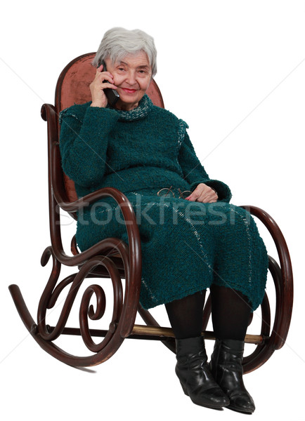 Oude vrouw telefoon afbeelding vergadering schommelstoel mobiele telefoon Stockfoto © RazvanPhotography