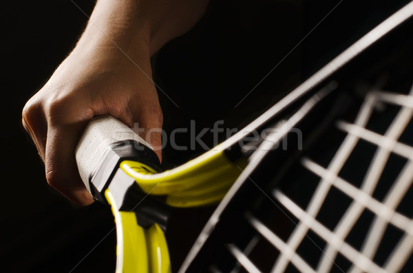 Hand on grip and swinging a tennis racket. Isolated on black bac Stock photo © razvanphotos
