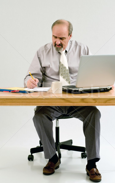 Businessman doing paperwork at his desk Stock photo © rcarner